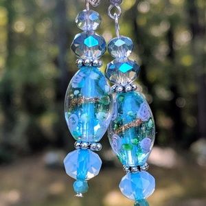 Turquoise hand blown beads with pink flowers.